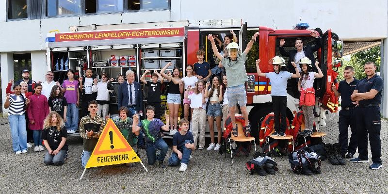 Schüler des PMHG und Bürgermeister Kalbfell vor einem Feuerwehrauto
